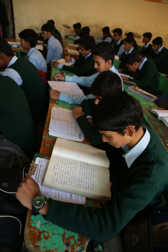 The Art of Drawing Readers In: Your attractive post title goes here Group of boys reading and studying in a classroom setting, focusing on education.