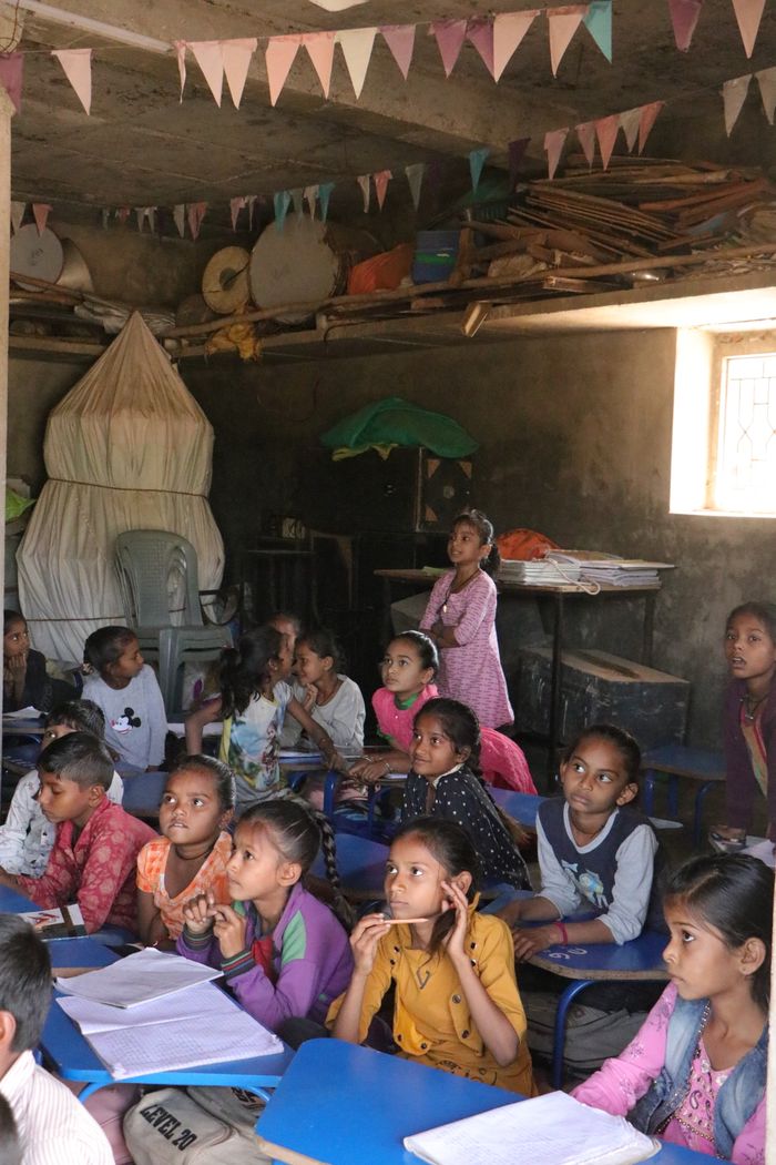 Crafting Captivating Headlines: Your awesome post title goes here A group of children attentively learning in a rural classroom in Banaskantha, India.